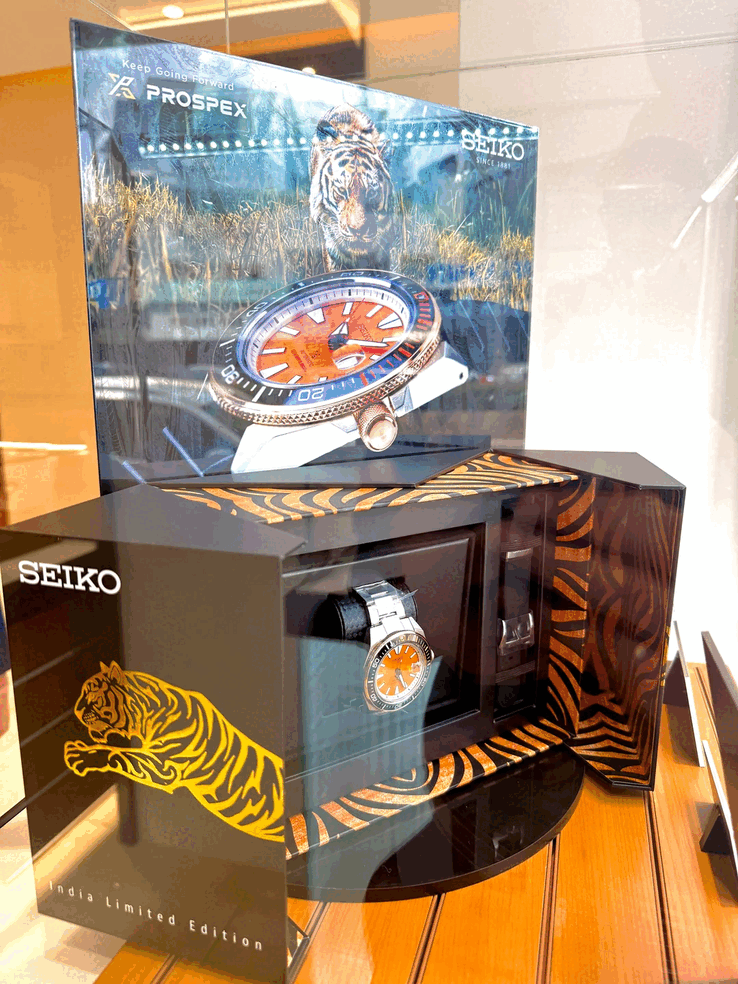 Seiko Prospex HBB005K1 displayed in its tiger-themed presentation box, featuring orange-and-black tiger-stripe detailing and a black silicone strap.