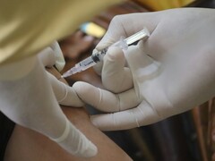  A person receiving an injection in the arm (Image source: Mufid Majnun via Unsplash; cropped)