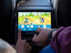 Kids playing arcade games at the back of a Tesla Model Y. (Image source: Tesla)