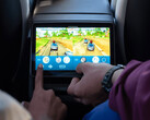 Kids playing arcade games at the back of a Tesla Model Y. (Image source: Tesla)