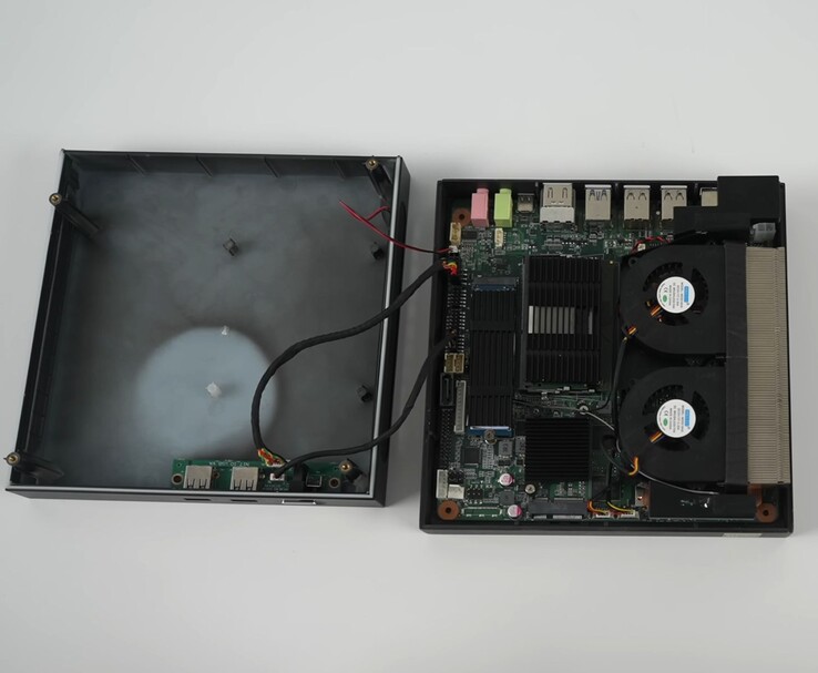 Yohris mini gaming PC opened up, showing dual-fan cooling system, motherboard, and upgradeable slots (Image source: ETA Prime/YouTube)