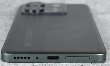 bottom of the chassis (speaker, microphone, USB port, SIM/microSD tray)