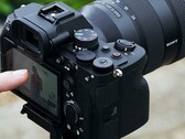 Sony A7 4 mirrorless camera on a tripod with operator handling