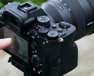 Sony A7 4 mirrorless camera on a tripod with operator handling