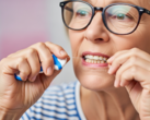 An image of a woman flossing. Dental flossing could become a new means of vaccination (Image source: AI-generated image)