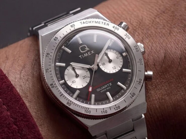 Timex Q Timex Continental Chronograph TW2Y93200 on a wrist, featuring a black radial CD-style dial, two silver sub-dials, tachymeter bezel, luminous markers, and an integrated stainless-steel bracelet.