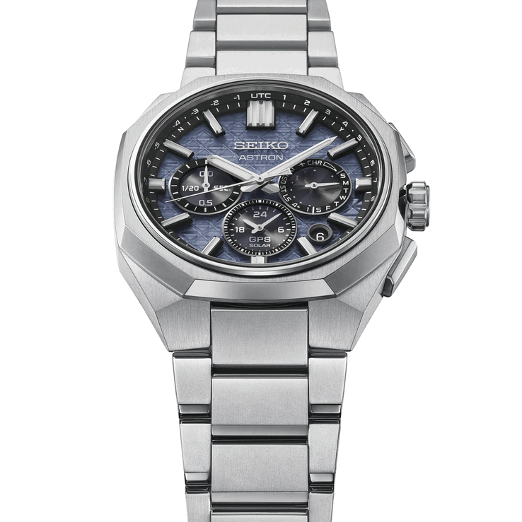 Angled front view of the Seiko Astron HAB001 showing its faceted titanium bezel, integrated bracelet, and textured blue dial.