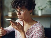 Woman speaking into a smartphone