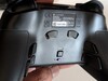 Back showing trigger stop mechanism, profile button, and connection switcher