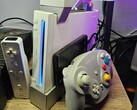 A modded Nintendo Wii with a GameCube controller next to it
