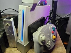 A modded Nintendo Wii with a GameCube controller next to it