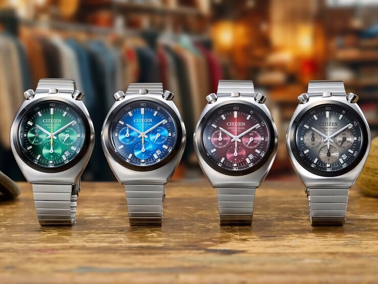 Four Citizen Tsuno Chronograph watches displayed side by side on a wooden surface, featuring green, blue, red, and gray gradient dials, stainless steel