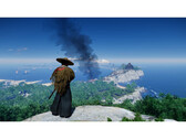 A landscape shot from Ghost of Tsushima showcasing Jin standing on a mountain overlooking the island. (Image Source: Steam)