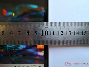 About 11 mm from the edge of the screen to the edge of the lid