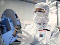 Intel aims for foundry break-even in 2027 as 18A node enters volume ramp. Pictured: A worker holding a silicon wafer (Image source: Intel)