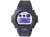 Casio G-Shock DW-6900 x F.C. Real Bristol with the blue EL backlight illuminated, revealing a hidden red Bristol logo behind the digital display.