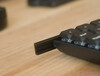 The keyboard has a plastic bottom case with aluminium rails and wood side panels to balance weight, stiffness, and aesthetics. 