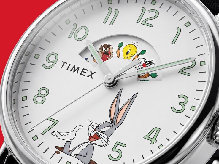 Close-up of the Timex Looney Tunes watch dial showing Bugs Bunny beneath the hands and Tweety Bird displayed in the rotating character window, alongside green-outlined hour markers and carrot graphics.