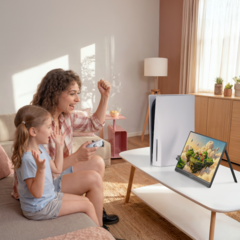 Woman and child playing PS5 game on portable monitor