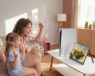 Woman and child playing PS5 game on portable monitor