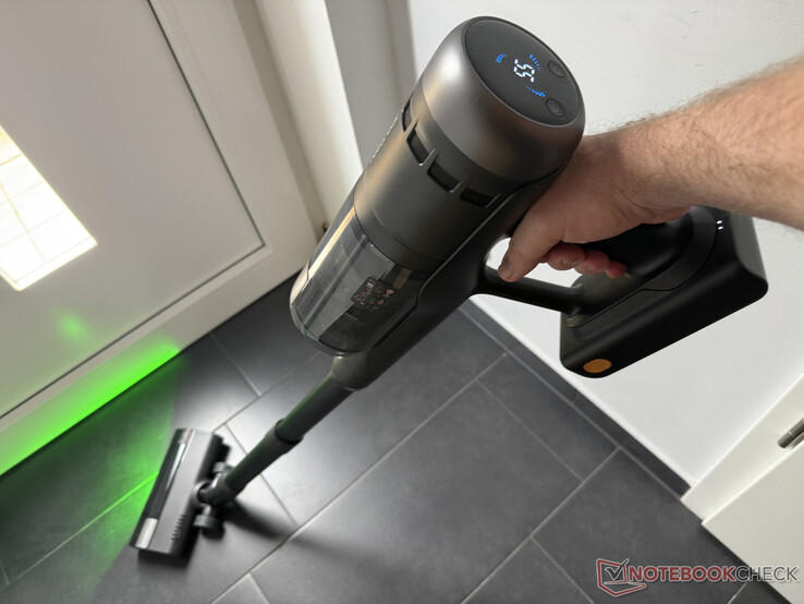 Roborock H60 Ultra cleaning the floor, on the top the rudimentary display
