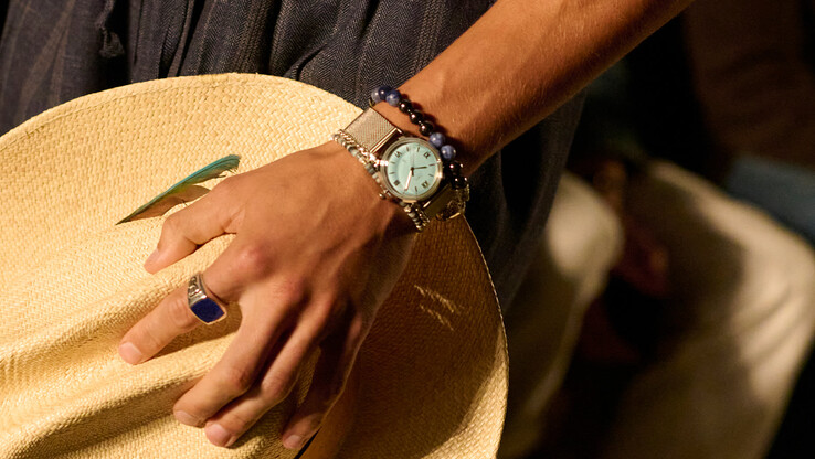 Person wearing the aqua blue Timex x Todd Snyder Marlin Mesh watch with a stainless steel bracelet.