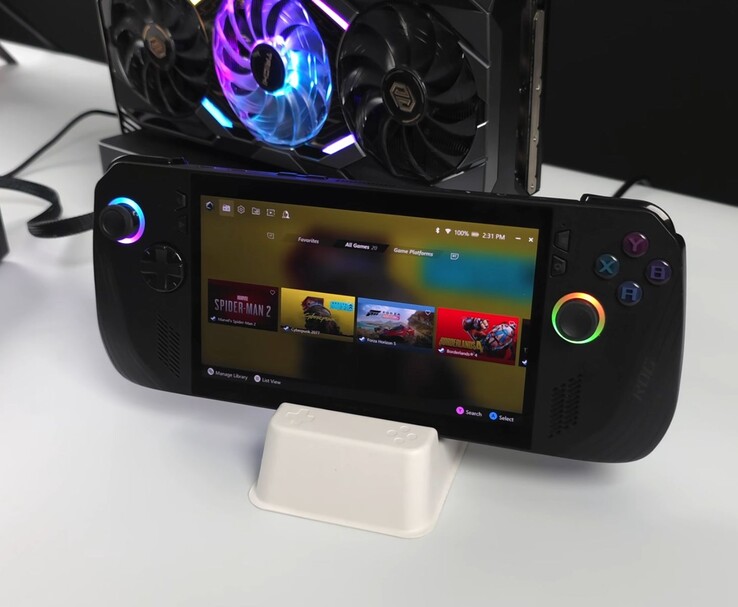 Asus ROG Ally X handheld connected to an AMD Radeon RX 9070 XT in an external Oculink eGPU dock, showing games including Spider-Man 2, Cyberpunk 2077, Forza Horizon 5, and Borderlands 4 on its screen (Image source: ETA Prime via YouTube)