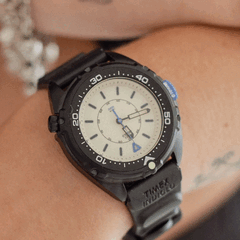 The Timex Intrepid x Dimepiece Blackout Edition features a black stainless steel case, cream dial and purple accents