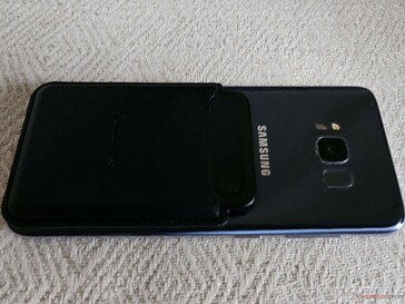 The magnetic cover attaches securely to the smartphone if no case is used; otherwise, the included magnetic ring is used.