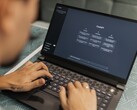 A person is typing on a laptop with the ChatGPT homepage open