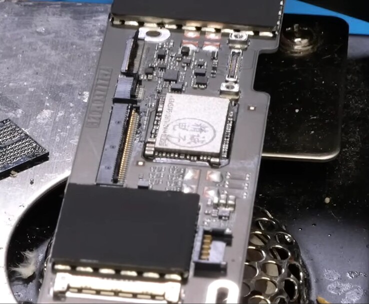 MacBook Neo logic board with 1 TB NAND chip installed