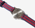 Rear view of the Noah x Timex MK1 Anchor watch showing its engraved stainless steel caseback and navy-and-red fabric strap.