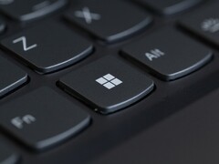 Close-up of a black laptop keyboard with the Windows key in focus