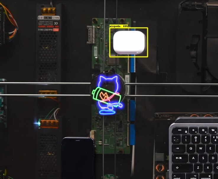 HTX Studio’s AirPower desk charging AirPods as the animated cat follows the charging coil.
