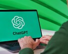 Person typing on a laptop showing the ChatGPT logo on screen