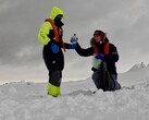 Researchers Mariam Naseem and Marc Neveu sampling and bottling brine from sea ice in Antarctica