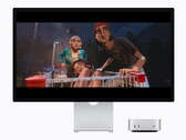 The image shows the new M6 Mac mini next to a Studio display. Some sort of a movie is being played 