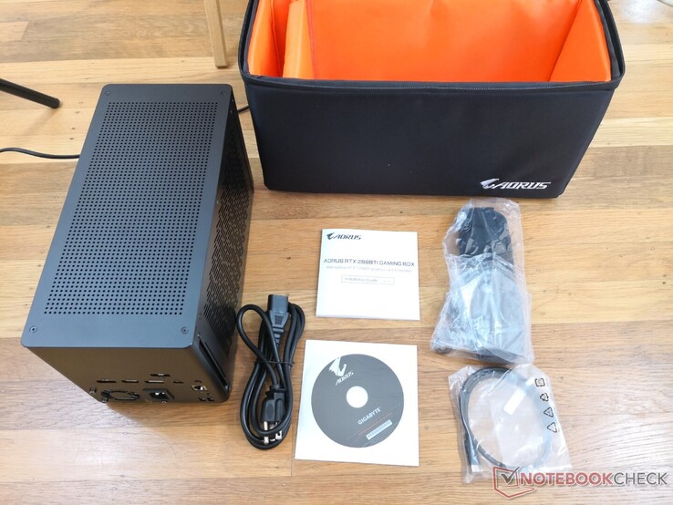Retail box includes a carrying case, leather carrying strap, AC power cable, drivers disc, manual, and a short 0.5 m Thunderbolt 3 cable. We recommend downloading the latest drivers online instead of using the disc