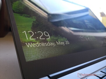 Display is glossy, but there is no edge-to-edge glass protection and it is not touchscreen