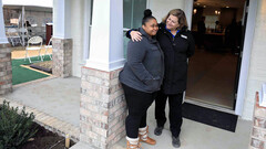 April Stringfield (left), in front of their new 3D-printed house (image: Habitat)