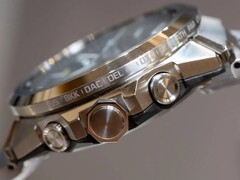 Side view of a Casio G-Shock GST-W1000 series watch showing its stainless steel case, pushers, crown, integrated bracelet, and engraved city names around the bezel.