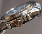 Side view of a Casio G-Shock GST-W1000 series watch showing its stainless steel case, pushers, crown, integrated bracelet, and engraved city names around the bezel.