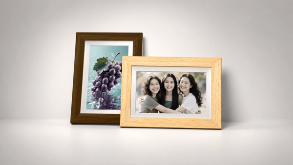 Two Bigme digital photo frames displaying grape and family photos.