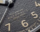 Close-up of the Timex Expedition Field Post Titanium’s textured black dial with Arabic numerals, luminous hands and markers, and date window.