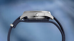 Side profile of the Peanuts x Timex Marlin Jet Automatic showing the stainless steel case, domed Hesalite crystal covering the bezel, and blue textured fabric strap.