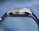 Side profile of the Peanuts x Timex Marlin Jet Automatic showing the stainless steel case, domed Hesalite crystal covering the bezel, and blue textured fabric strap.