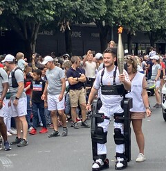 Paralyzed Kevin Piette walks with Olympics 2024 torch while wearing Wandercraft Atalante X exoskeleton. (Image source: Jean Louis Constanza, Wandercraft) 