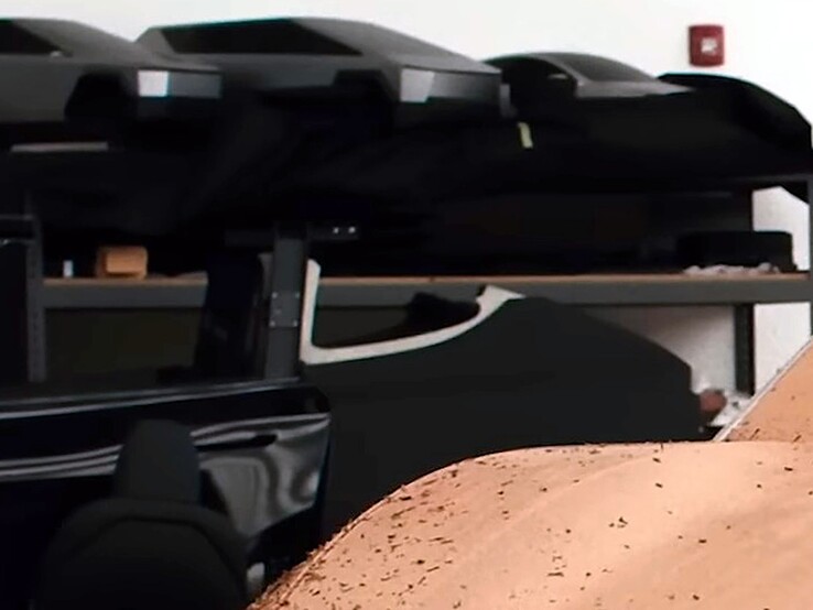 Cyber SUV scale models on the design studio shelves.