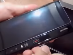 The revised Huawei Mate X has a red button for unfolding the device. (Image source: YouTube)