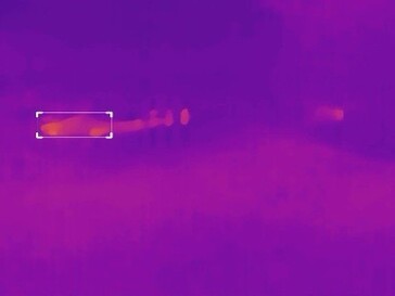 There are three individuals on the road in this foggy shot